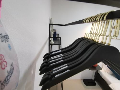 a rack with a bunch of black accordions at Chu-Cha's Rooms in Koh Samui 