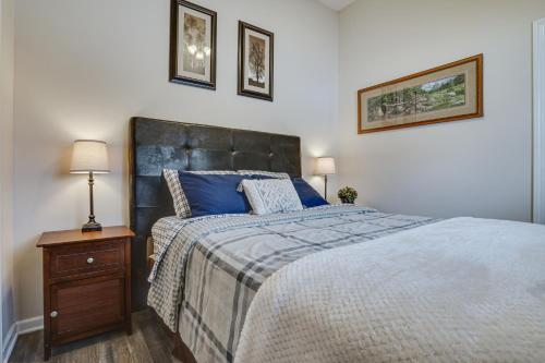 a bedroom with a large bed with blue pillows at Peaceful Ellsworth Vacation Rental with Grill 