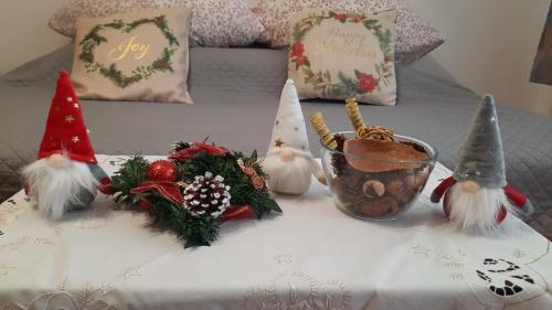 a table with christmas decorations on a bed at Bubu Apartament in Petroşani