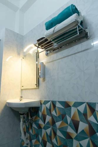 a bathroom with a sink and a mirror at OceanBliss_Homestay04 in Villupuram