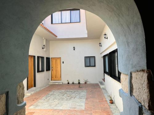 an archway in a building with a door and windows at Suites Patio Antequera in Oaxaca City