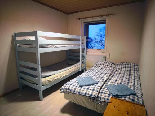 a small bedroom with a bunk bed and a window at The Private Quarters in Vårsta