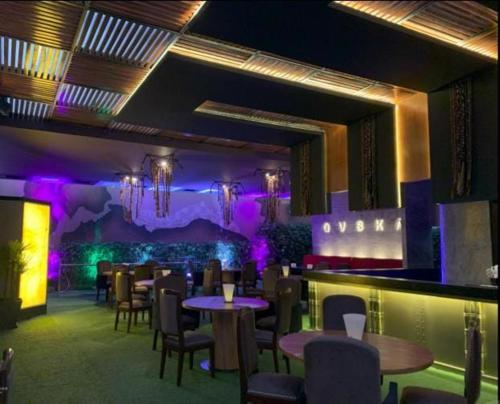 a restaurant with tables and chairs and purple lighting at Dorado Hotel Boutique - Tacna in Tacna