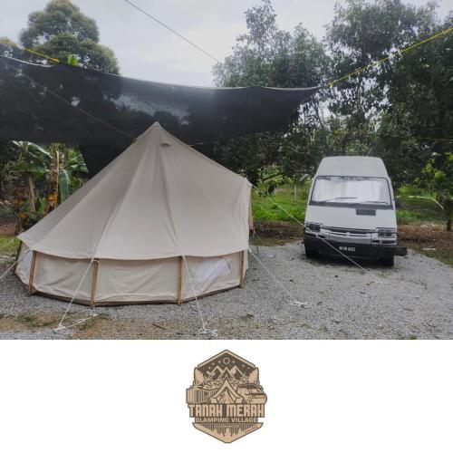 a white van is parked next to a tent at Tanah Merah Glamping Village (TMGV) in Kuala Kangsar