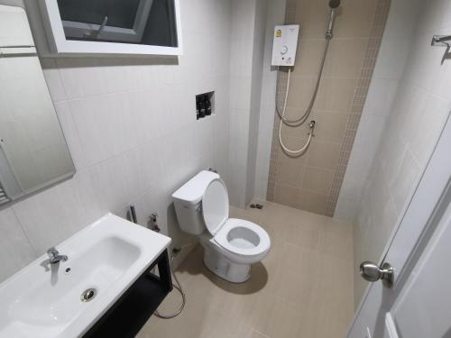 a bathroom with a toilet and a sink and a shower at Chu-Cha's Rooms in Koh Samui 