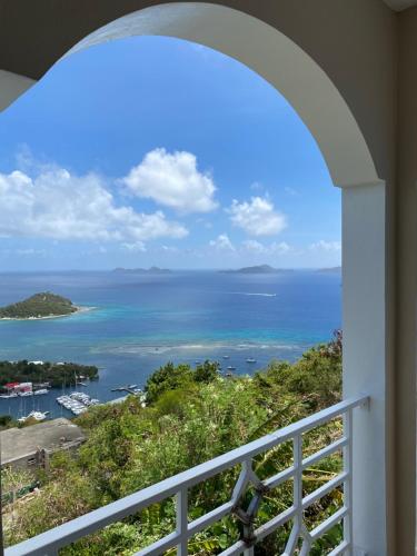 a view of the ocean from a balcony at Top of the Hill Blue Sunshine in Long Swamp