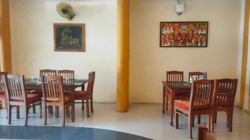 a dining room with a table and chairs at Sneha Inn in Kannur