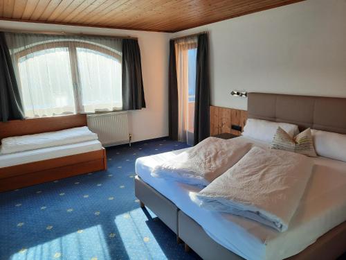 a bedroom with a large bed and a window at Haus Paznaun in Kappl