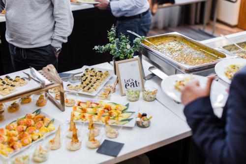a table with appetizers and plates of food on it at Hotel Timisoara in Timişoara