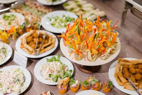 a table full of plates of food with different foods at Hotel Timisoara in Timişoara