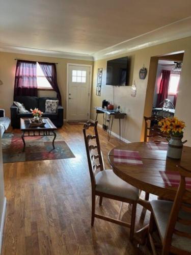 a living room with a table and a dining room at Perfect place quiet neighborhood, great for the family. in Saginaw