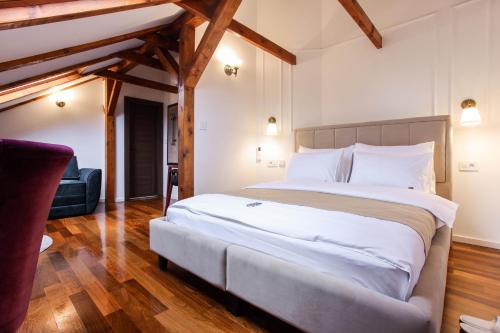 a bedroom with a large white bed with wooden beams at Villa 1927 in Belgrade
