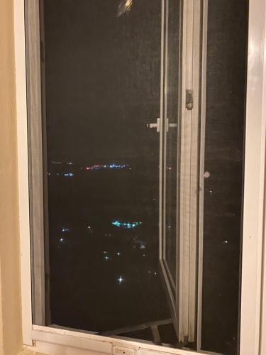 a window with a view of a city at night at Top of the Hill Blue Sunshine in Long Swamp