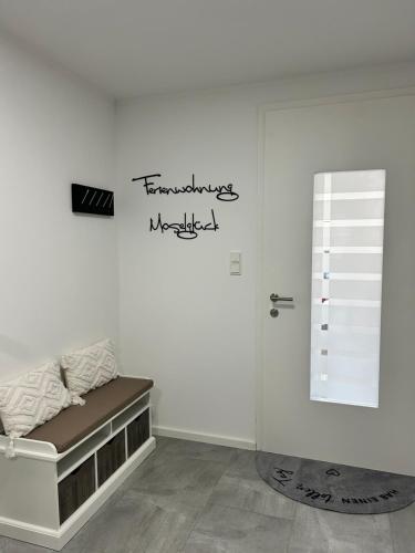 a white wall with a bed in a room at Moselglück in Pölich