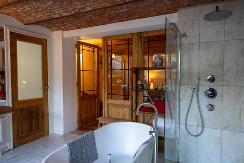 a bathroom with a bath tub and a shower at Heaven in Antwerp in Antwerp