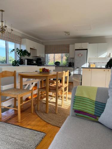 Una cocina y una sala de estar con mesa y sillas. en Between Mountain and Sea, en Ciudad del Cabo