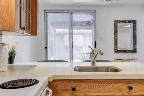 a kitchen with a sink and a counter top at Comfortable Whitby 2 Bedroom Lower Suite in Whitby