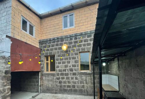 a brick building with lights on the side of it at Kotun: a spacious house in Gyumri in Gyumri