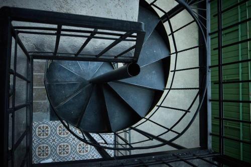 a spiral staircase in a building with a window at Kotun: a spacious house in Gyumri in Gyumri