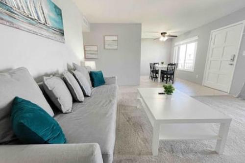 a living room with a couch and a table at Perfect Beach Getaway with Dock AND Pet Friendly in St. Pete Beach