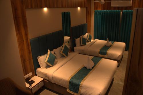 Posteľ alebo postele v izbe v ubytovaní Hotel Tanisha