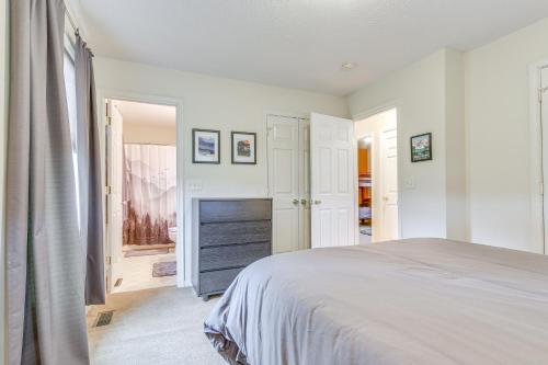a white bedroom with a bed and a fireplace at Charming Shenandoah Retreat with Deck! in Shenandoah