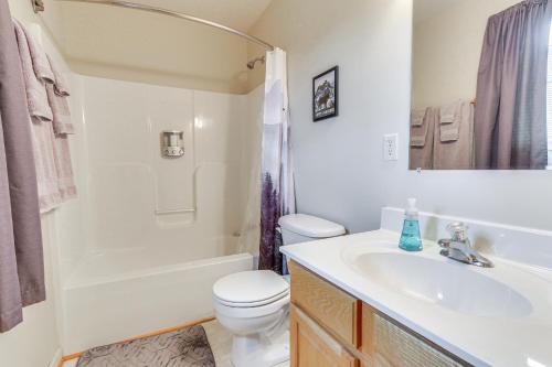 a bathroom with a sink and a toilet and a tub at Charming Shenandoah Retreat with Deck! in Shenandoah