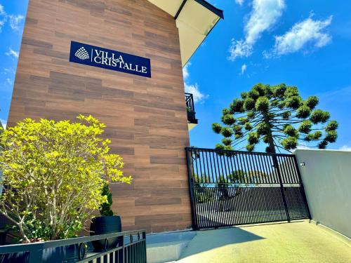 a building with a sign that reads milla christie at Villa Cristalle - Campos do Jordão in Campos do Jordão