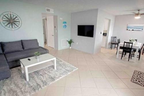 a living room with a couch and a table at 2x1 Beach Condo! Walk to the Beach AND Restaurants! in St Pete Beach