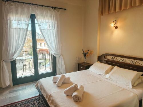 a bedroom with a bed with towels on it at Filimon GuestHouse Villa in Xanthi