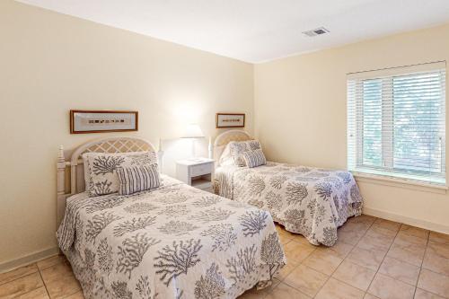 a bedroom with two beds and a window at Bluff Villas 1673 in Hilton Head Island