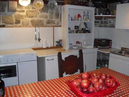 a kitchen with a table with a bowl of apples on it at Incantevole rifugio nel castello di Ahrensperg in Pulfero