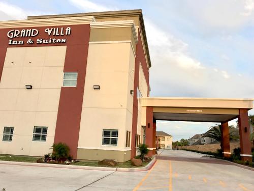 a building with a sign that reads grand villinian inn and suites at Grand Villa Inn and Suites Westchase/Chinatown in Houston