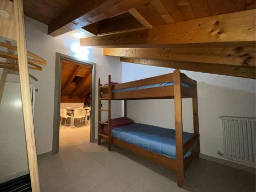 a bedroom with bunk beds in a room with a doorway at L'Acero Rosso in Prosto di Piuro