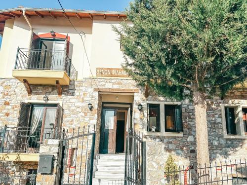 a building with a tree in front of it at Filimon GuestHouse Villa in Xanthi