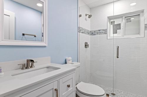 a bathroom with a toilet and a sink and a shower at Caloosa Cottage at Palm View Inn of Sanibel with Bikes in Sanibel