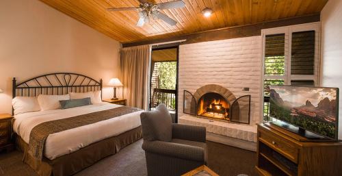 a bedroom with a large bed and a fireplace at Arroyo Roble Resort - Timeshare Week in Sedona