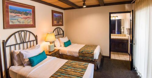 a hotel room with two beds and a bathroom at Arroyo Roble Resort - Timeshare Week in Sedona