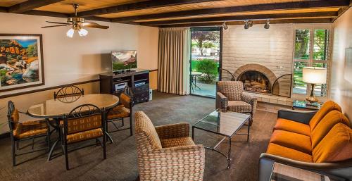 a living room with a table and a fireplace at Arroyo Roble Resort - Timeshare Week in Sedona