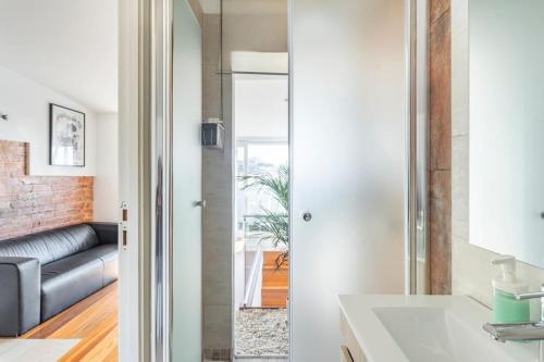 a kitchen with a sink and a living room at Lisbon Skyline Terrace in Lisbon