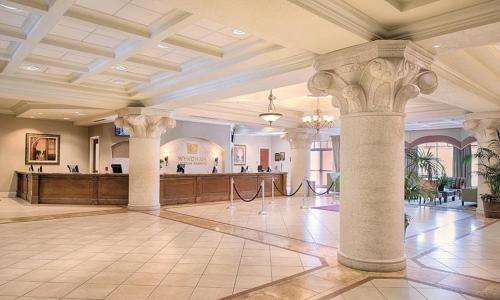 a large lobby with columns and a bar in the background at Bonnet Creek Resort 1 Bedroom 1 BA Deluxe Villa in Orlando
