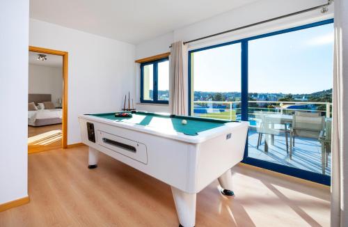 a pool table in a room with a balcony at Penthouse 160sqm wide Terraces Pool view & private Hot Tub & Parking in Albufeira