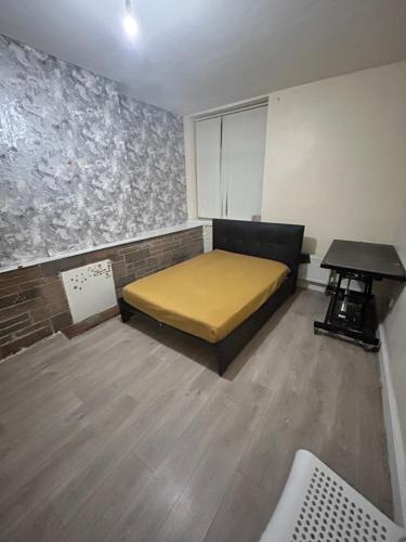 a room with a bed and a table in it at 40 vicarage street in Failsworth