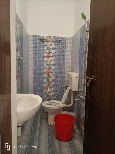 a bathroom with a white toilet and a sink at Dona Residency in Nedumbassery