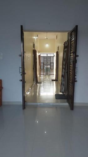 a mirror reflecting a hallway with doors in a room at laxmihomestay in Khajurāho