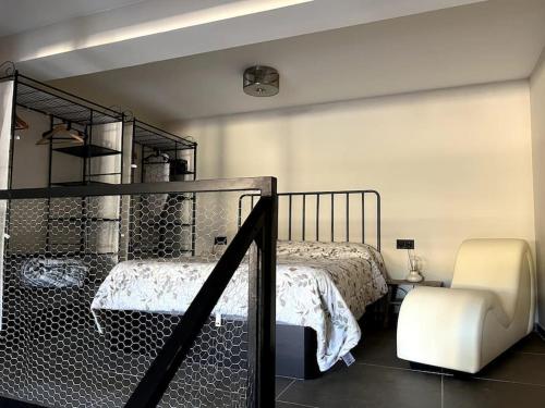 a bedroom with a bunk bed and a chair at El Gallinero, Loft con sauna y jacuzzi - Housevanlive in Casas Altas