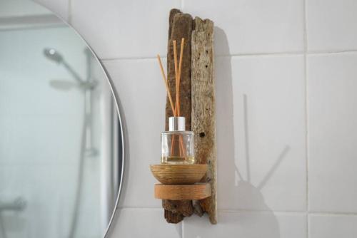 a bathroom with a soap dispenser on a mirror at 2 Bed Flat with garden nr Beach in South Hayling