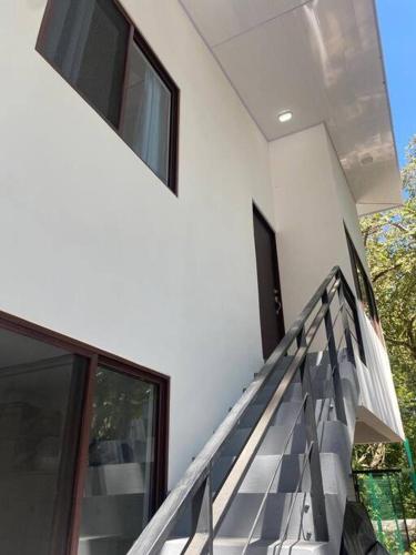 a staircase leading up to a white building at Peaceful Apartment in Tamarindo, 50m to the Beach - Sofia Apartments in Tamarindo