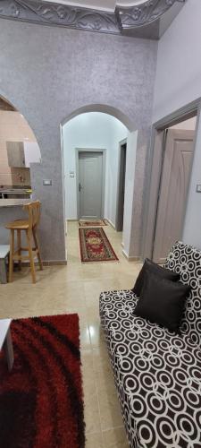 a living room with a bed and a dining room at Ahmed House 1 in Safaga 