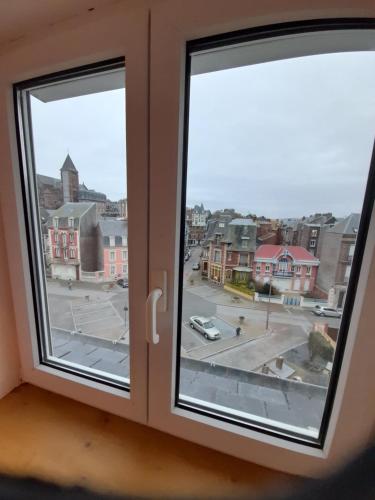 a view of a city from a window at "Le JUGUILI" 46m2 en front de Mer - 4 personnes - animaux OK - Entièrement rénové - Haut de gamme - wifi in Mers-les-Bains